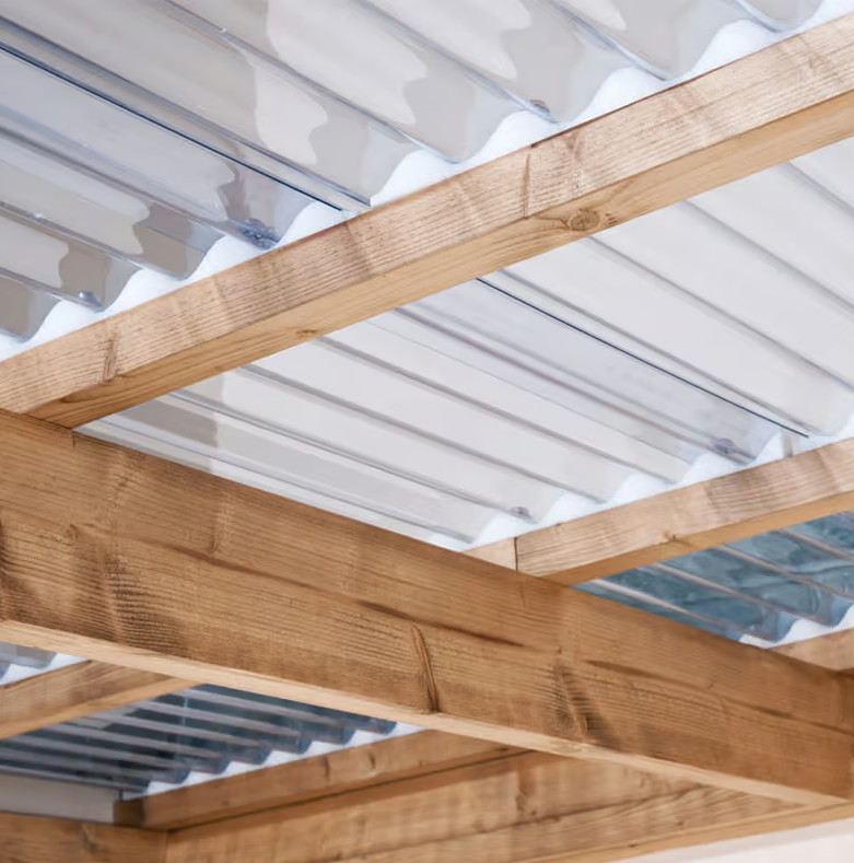 Wooden beams of a roof structure with a white corrugated material background