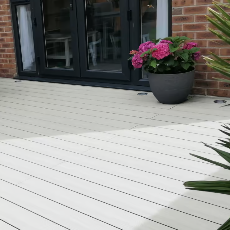 Two beige composite decking boards on a white background